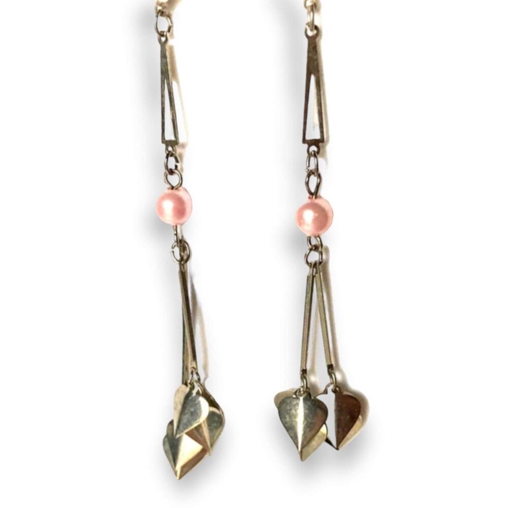 Long silver tone dangle post earrings with pink accent